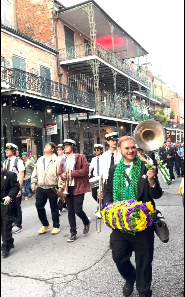 Marching band in the French Quarter with bubbles in background